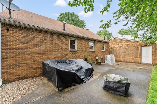 2026 34th St NW, Canton, OH 44709 - back of house featuring a patio, brick siding, and a shingled roof