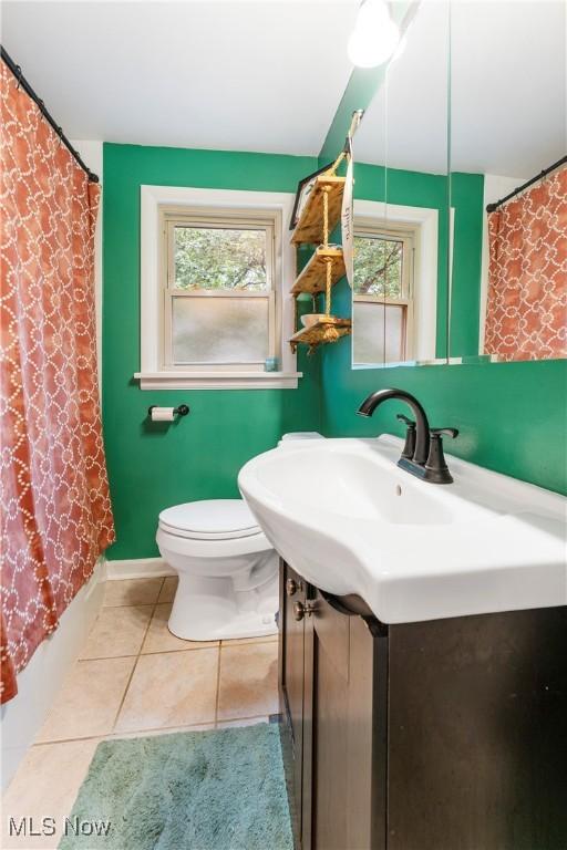 2026 34th St NW, Canton, OH 44709 - full bathroom with vanity, plenty of natural light, tile patterned floors, and a shower with curtain