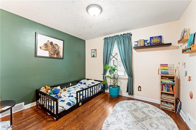 2026 34th St NW, Canton, OH 44709 - bedroom with wood finished floors and a baseboard radiator