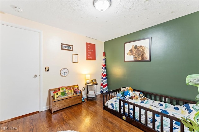 2026 34th St NW, Canton, OH 44709 - bedroom with wood finished floors and a textured ceiling