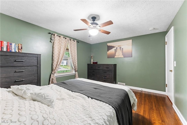 2026 34th St NW, Canton, OH 44709 - bedroom with wood finished floors, a textured ceiling, and a ceiling fan