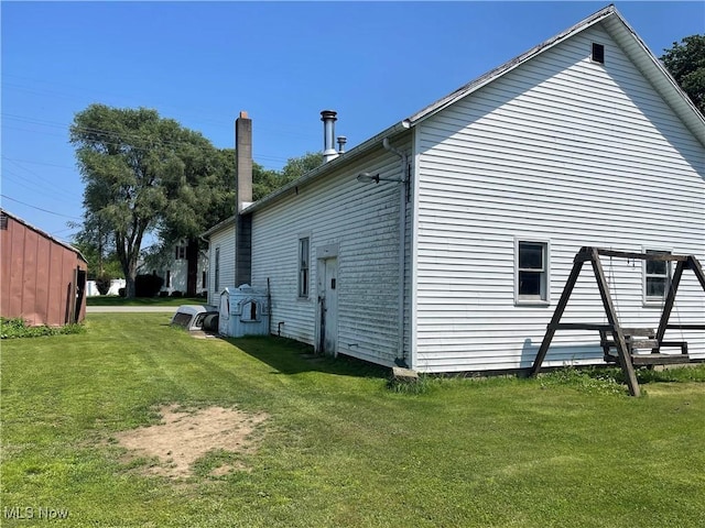 320 E Union Ave, West Lafayette, OH 43845 - view of side of home featuring a lawn and a chimney