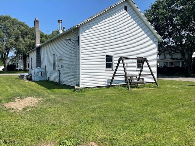 320 E Union Ave, West Lafayette, OH 43845 - view of property exterior with a yard and a chimney