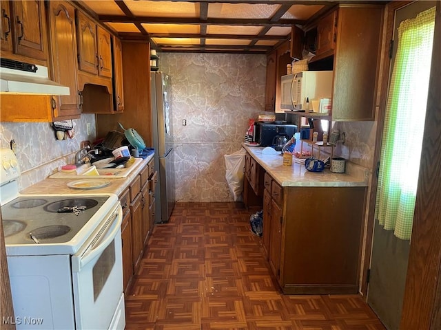 320 E Union Ave, West Lafayette, OH 43845 - kitchen featuring white appliances, under cabinet range hood, light countertops, brown cabinets, and wallpapered walls