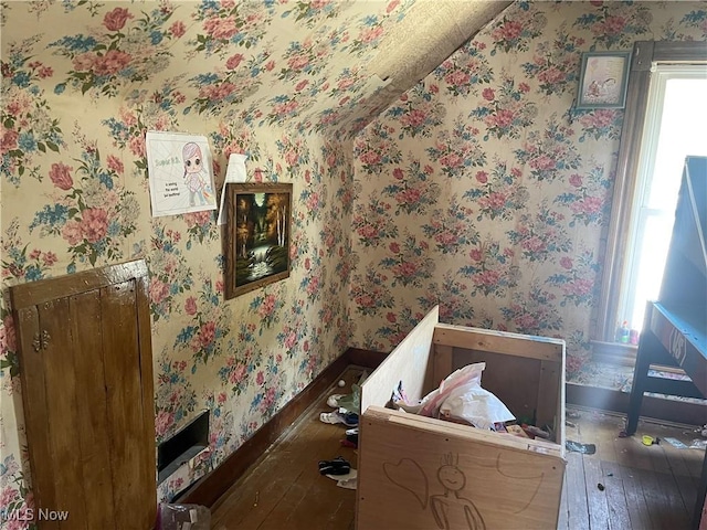 320 E Union Ave, West Lafayette, OH 43845 - bedroom featuring hardwood / wood-style floors, vaulted ceiling, and wallpapered walls