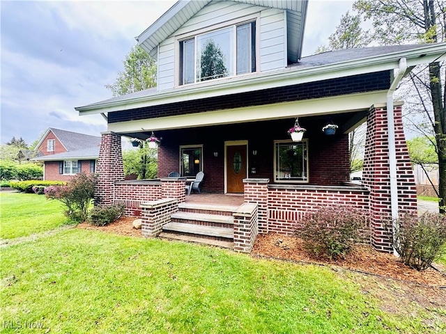 741 Jennings Ave, Salem, OH 44460 - view of front facade with covered porch, a front yard, and brick siding
