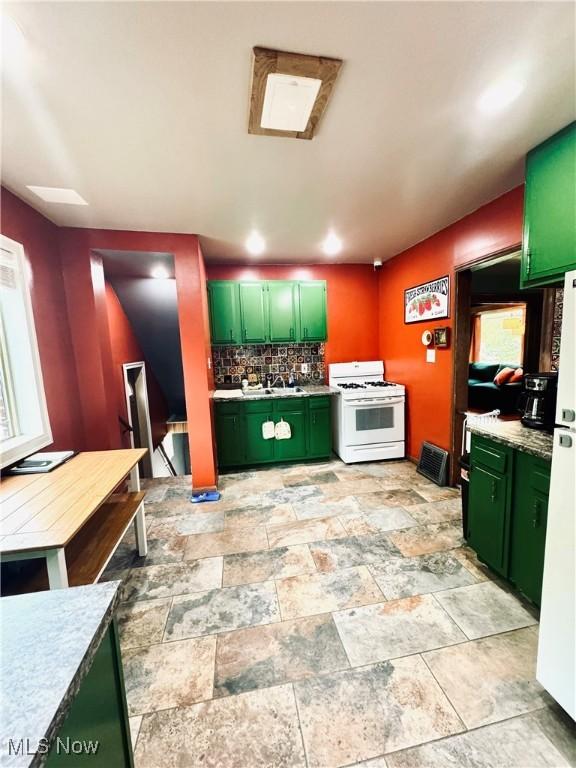 741 Jennings Ave, Salem, OH 44460 - kitchen featuring green cabinetry, white appliances, decorative backsplash, and light countertops
