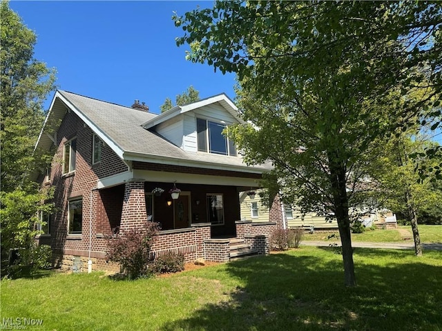741 Jennings Ave, Salem, OH 44460 - back of property with a porch, a yard, and brick siding