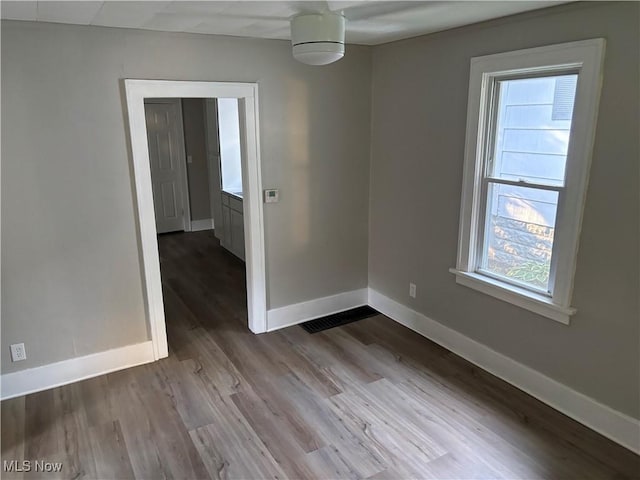 713 Virginia Ave, Akron, OH 44306 - unfurnished room featuring plenty of natural light and wood finished floors