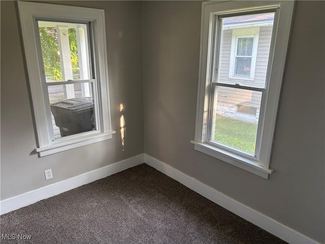 713 Virginia Ave, Akron, OH 44306 - spare room featuring baseboards and dark carpet