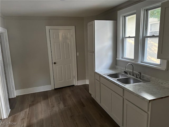 713 Virginia Ave, Akron, OH 44306 - kitchen featuring light countertops, dark wood-type flooring, and white cabinets