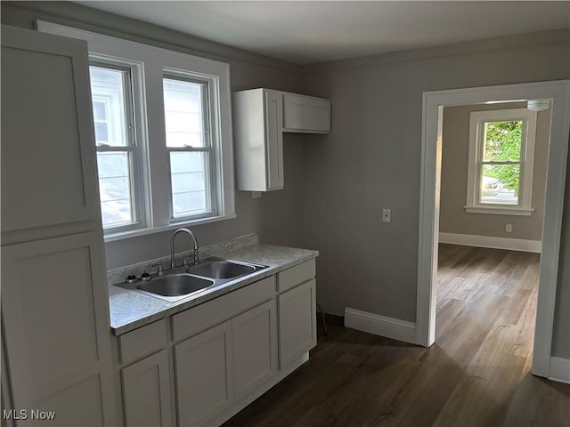 713 Virginia Ave, Akron, OH 44306 - kitchen featuring light countertops, dark wood-type flooring, and white cabinetry