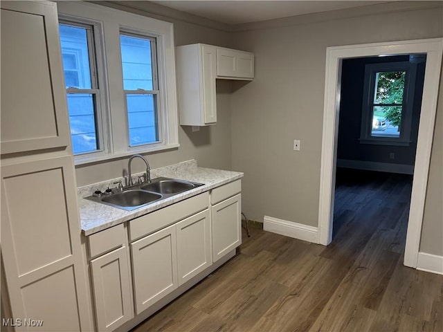 713 Virginia Ave, Akron, OH 44306 - kitchen featuring wood finished floors, light countertops, and white cabinets