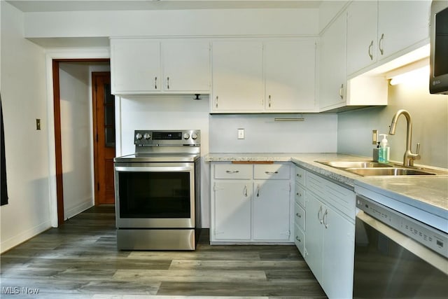 2803 Brunswick Rd, Youngstown, OH 44511 - kitchen with stainless steel appliances, white cabinetry, light countertops, and wood finished floors