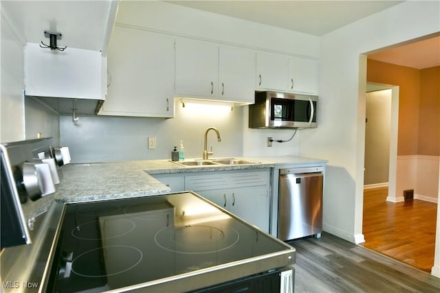 2803 Brunswick Rd, Youngstown, OH 44511 - kitchen featuring appliances with stainless steel finishes, dark wood-style floors, white cabinets, and light countertops