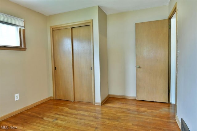 2803 Brunswick Rd, Youngstown, OH 44511 - unfurnished bedroom featuring wood finished floors and a closet