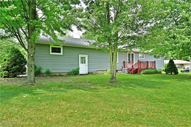 2803 Brunswick Rd, Youngstown, OH 44511 - rear view of property featuring a deck and a lawn