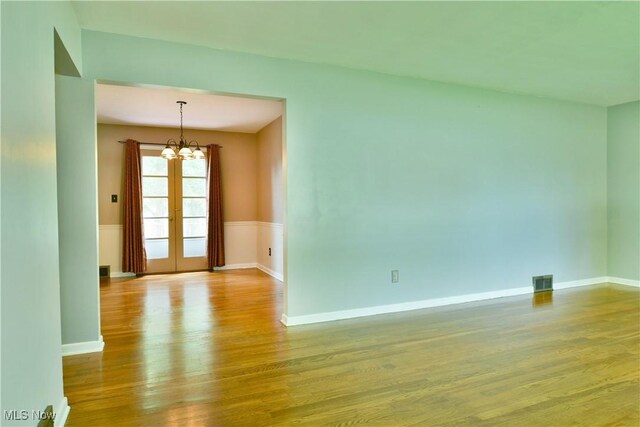 2803 Brunswick Rd, Youngstown, OH 44511 - spare room featuring wood finished floors and a chandelier