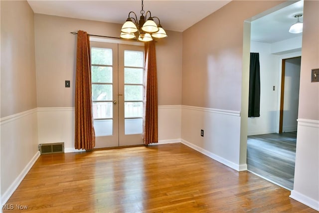 2803 Brunswick Rd, Youngstown, OH 44511 - spare room with a chandelier, wood finished floors, and french doors