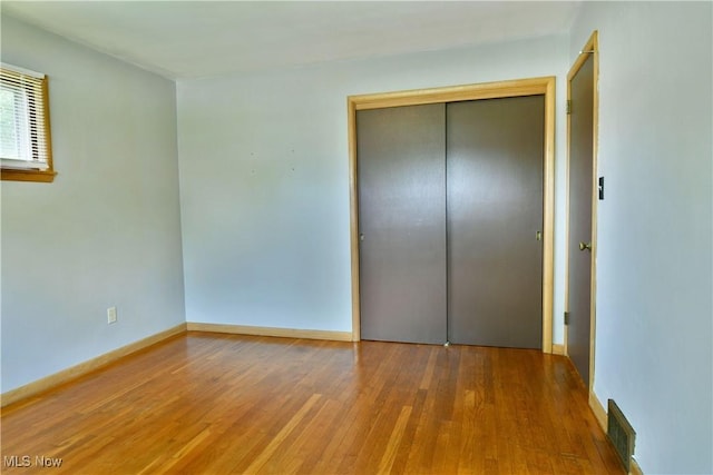 2803 Brunswick Rd, Youngstown, OH 44511 - unfurnished bedroom featuring wood finished floors and a closet
