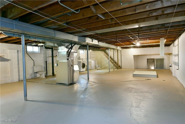 2803 Brunswick Rd, Youngstown, OH 44511 - below grade area featuring washer and dryer, heating unit, and stairway