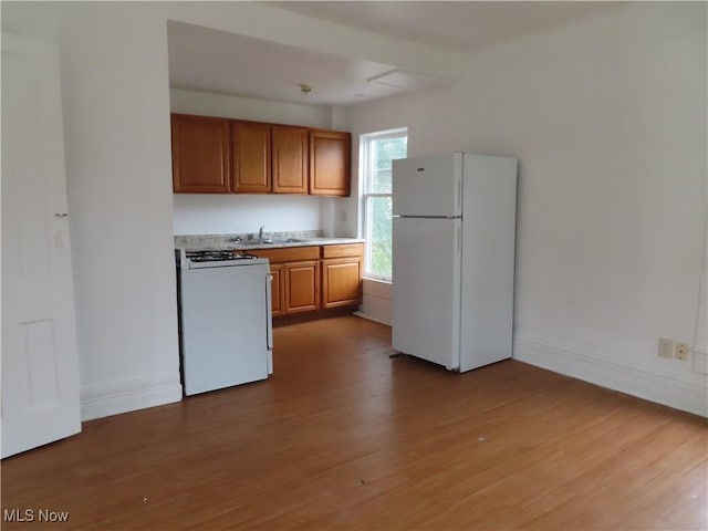 274 Wheeler St, Akron, OH 44304 - kitchen with white appliances, brown cabinets, wood finished floors, and light countertops