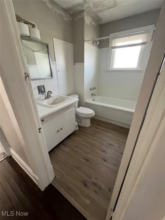 836 E 236th St, Euclid, OH 44123 - bathroom with wood finished floors, vanity, and  shower combination