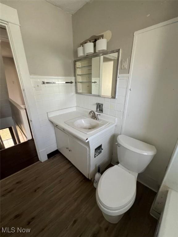836 E 236th St, Euclid, OH 44123 - bathroom with tile walls, wood finished floors, vanity, and wainscoting