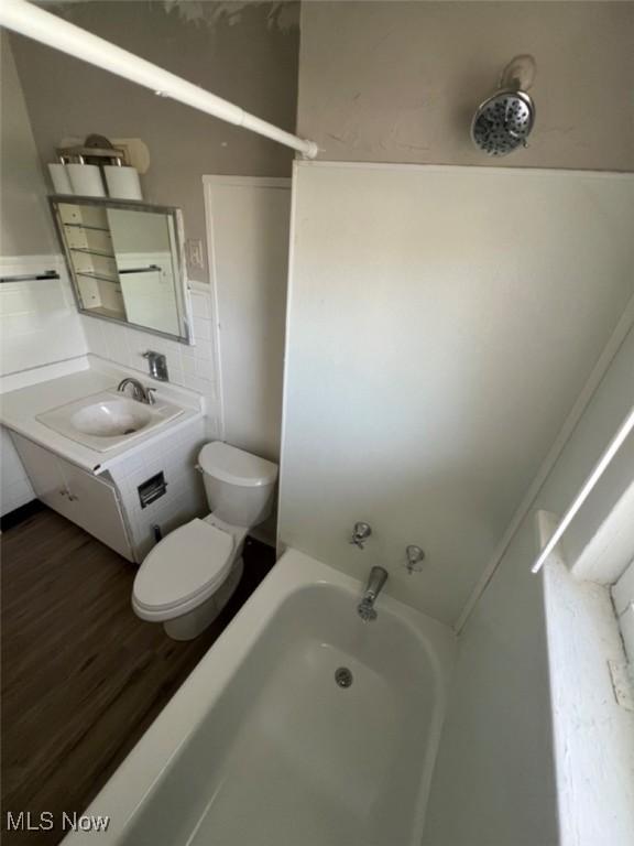836 E 236th St, Euclid, OH 44123 - bathroom featuring vanity, a bathtub, and wood finished floors