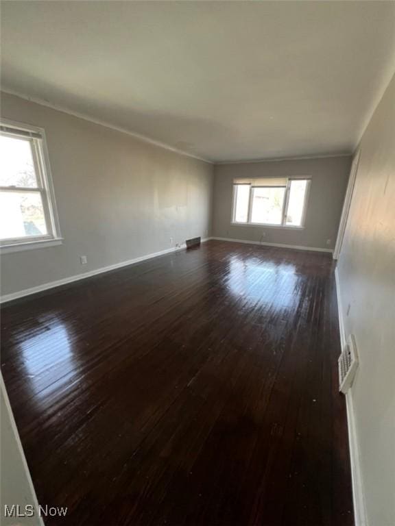 836 E 236th St, Euclid, OH 44123 - spare room featuring dark wood-style floors and crown molding