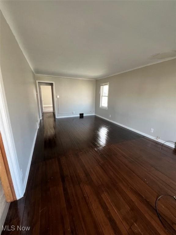 836 E 236th St, Euclid, OH 44123 - empty room featuring dark wood-type flooring and crown molding