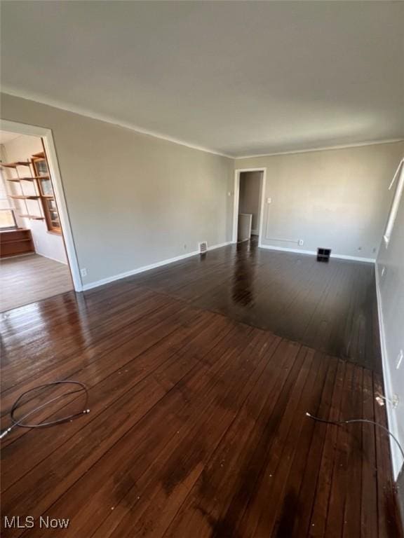 836 E 236th St, Euclid, OH 44123 - unfurnished living room featuring dark wood-style floors and ornamental molding