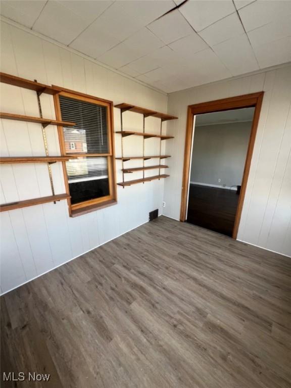 836 E 236th St, Euclid, OH 44123 - unfurnished room featuring wood finished floors and wood walls