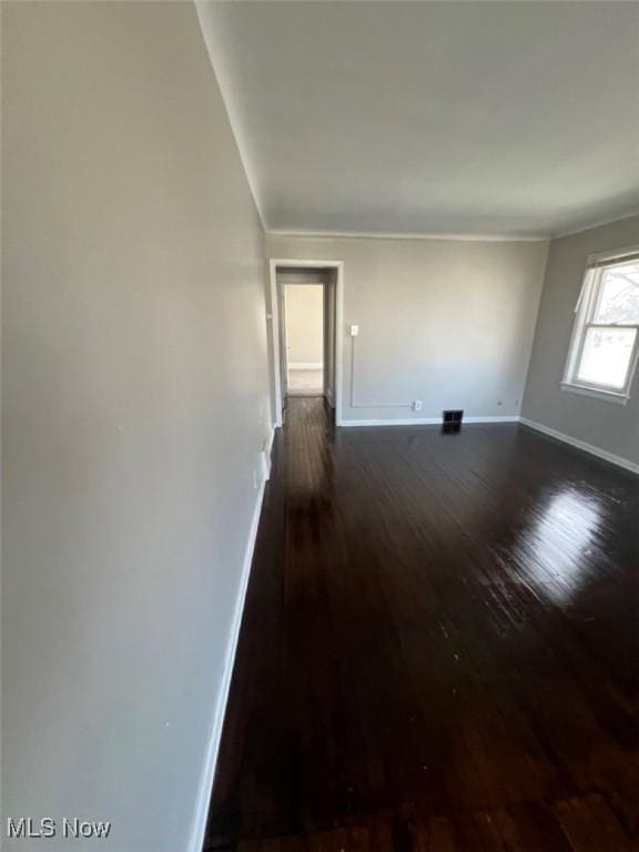 836 E 236th St, Euclid, OH 44123 - empty room featuring dark wood finished floors and ornamental molding
