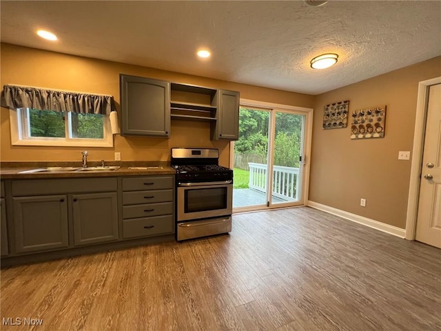 213 Turner Dr, Chardon, OH 44024 - kitchen featuring gas range, gray cabinets, wood finished floors, dark countertops, and open shelves