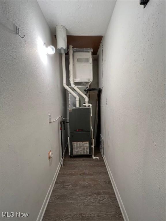 213 Turner Dr, Chardon, OH 44024 - hall with dark wood-style flooring and heating unit
