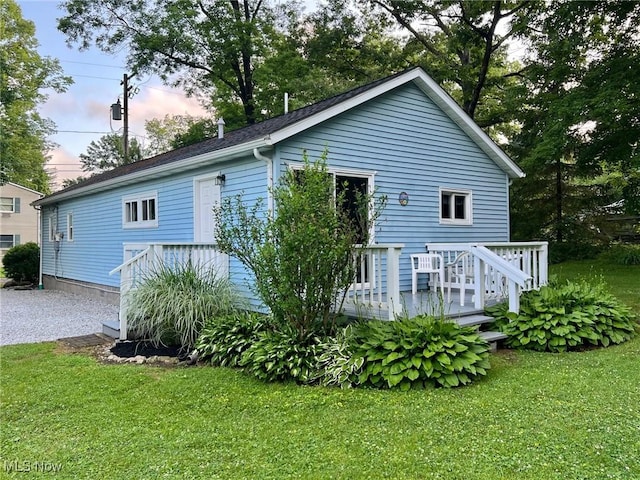 213 Turner Dr, Chardon, OH 44024 - back of house at dusk featuring a yard and a deck
