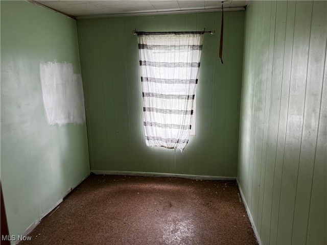 335 W New York Ave, Sebring, OH 44672 - unfurnished room featuring carpet floors and wood walls