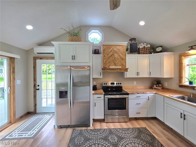 12779 State Route 700, Hiram, OH 44234 - kitchen featuring stainless steel appliances, premium range hood, lofted ceiling, healthy amount of natural light, and white cabinets