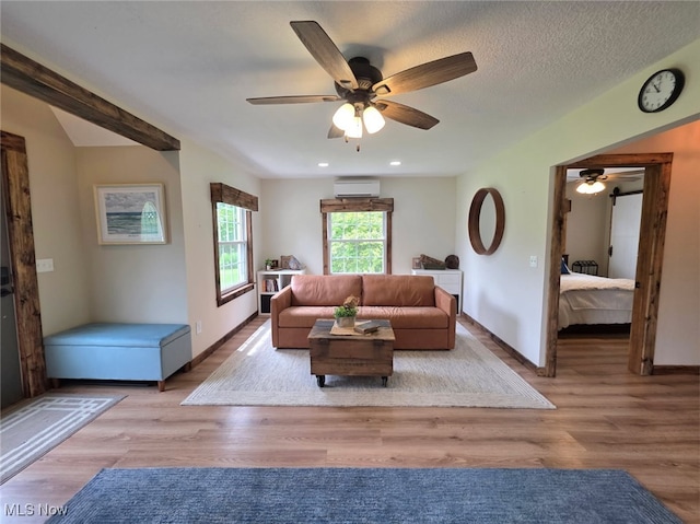 12779 State Route 700, Hiram, OH 44234 - living area featuring a wall mounted air conditioner, ceiling fan, wood finished floors, and recessed lighting