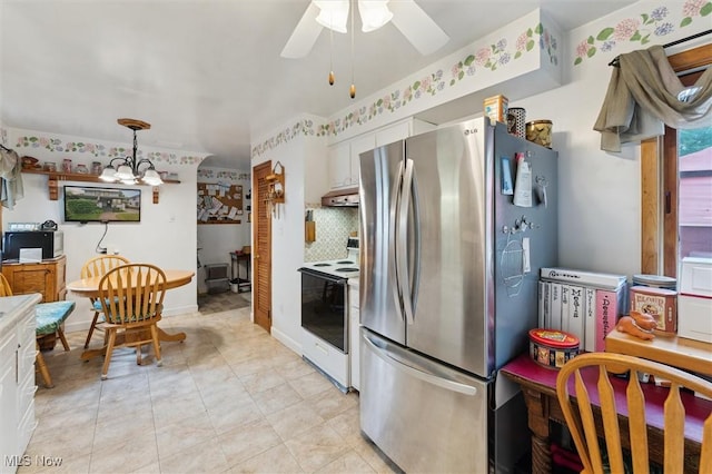 348 E Broad St, Newton Falls, OH 44444 - kitchen featuring white electric range oven, freestanding refrigerator, a ceiling fan, under cabinet range hood, and hanging light fixtures