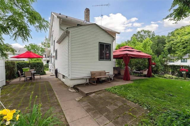 348 E Broad St, Newton Falls, OH 44444 - back of property featuring a patio, a chimney, and outdoor dining area