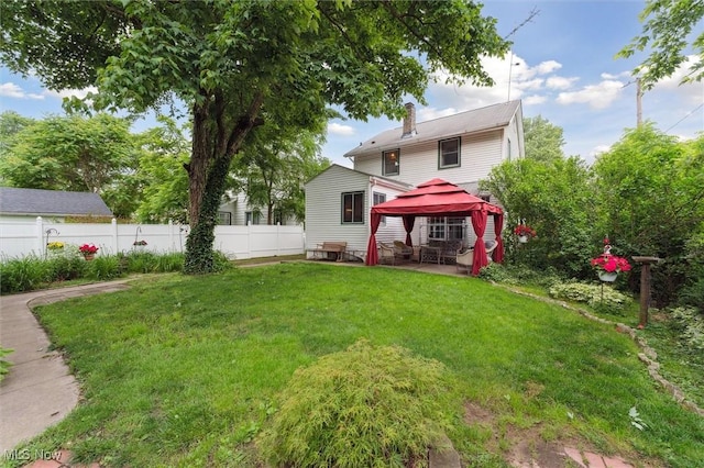 348 E Broad St, Newton Falls, OH 44444 - back of property with a gazebo, a chimney, and a patio area