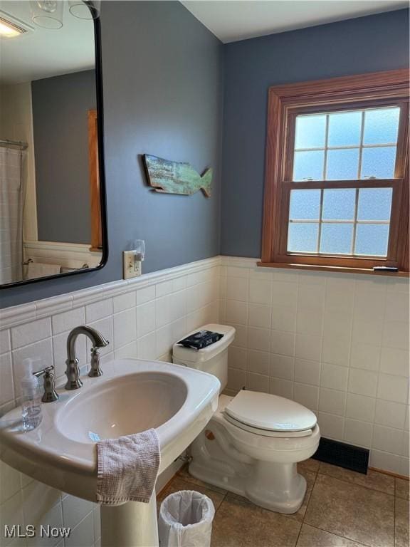 203 Park Ave, Middlebourne, WV 26149 - bathroom featuring tile walls, tile patterned flooring, and wainscoting