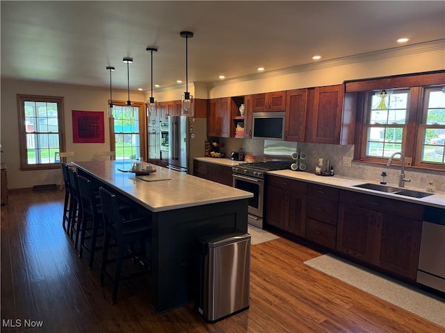 203 Park Ave, Middlebourne, WV 26149 - kitchen with stainless steel appliances, light countertops, a kitchen breakfast bar, backsplash, and recessed lighting