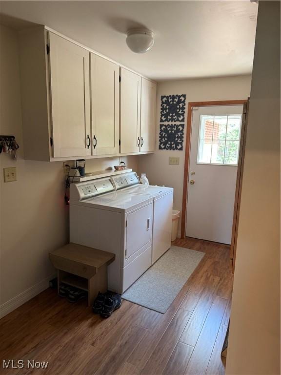 203 Park Ave, Middlebourne, WV 26149 - washroom with cabinet space, washing machine and clothes dryer, and wood finished floors