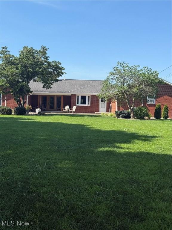 203 Park Ave, Middlebourne, WV 26149 - view of front of home with a front lawn and brick siding
