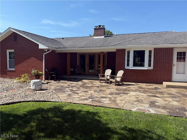 203 Park Ave, Middlebourne, WV 26149 - rear view of property with brick siding, a chimney, a patio area, french doors, and a shingled roof