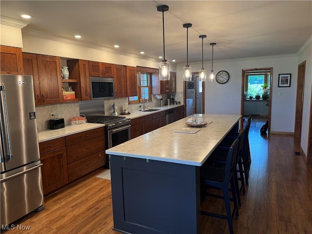 203 Park Ave, Middlebourne, WV 26149 - kitchen with stainless steel appliances, a breakfast bar area, a center island, open shelves, and light countertops