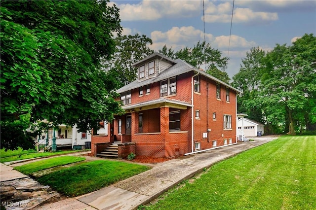 563 Atlantic, Warren, OH 44483 - american foursquare style home featuring brick siding, a front yard, an outdoor structure, and a garage